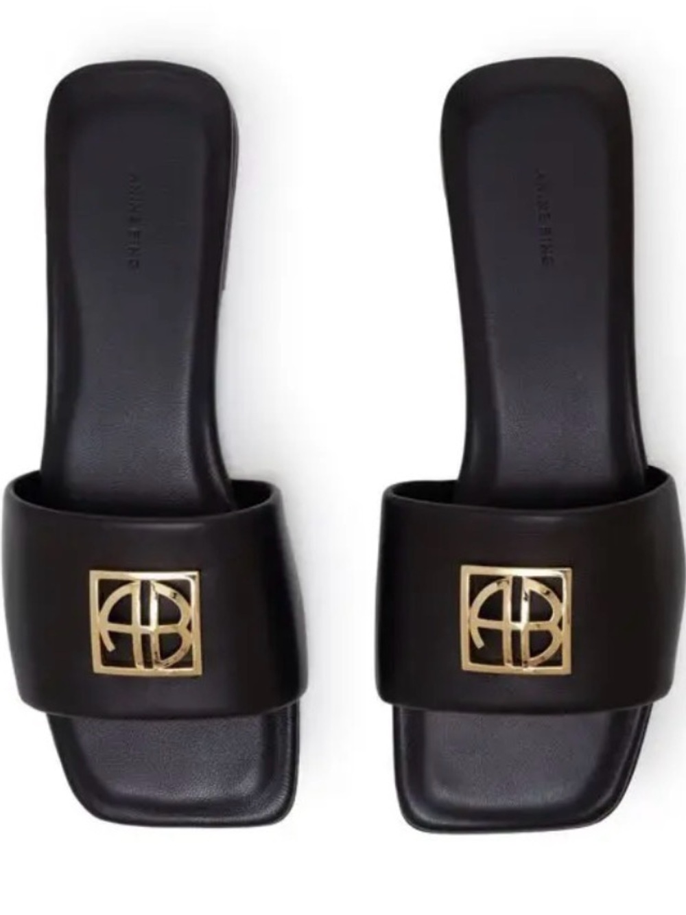 Anine Bing Black Slide Mules with Gold Logo Plaque